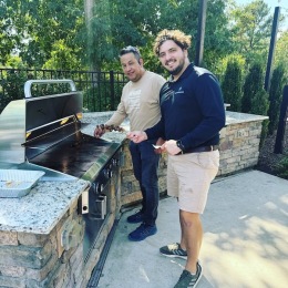 two men grilling food