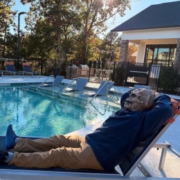 a man relaxing by a pool