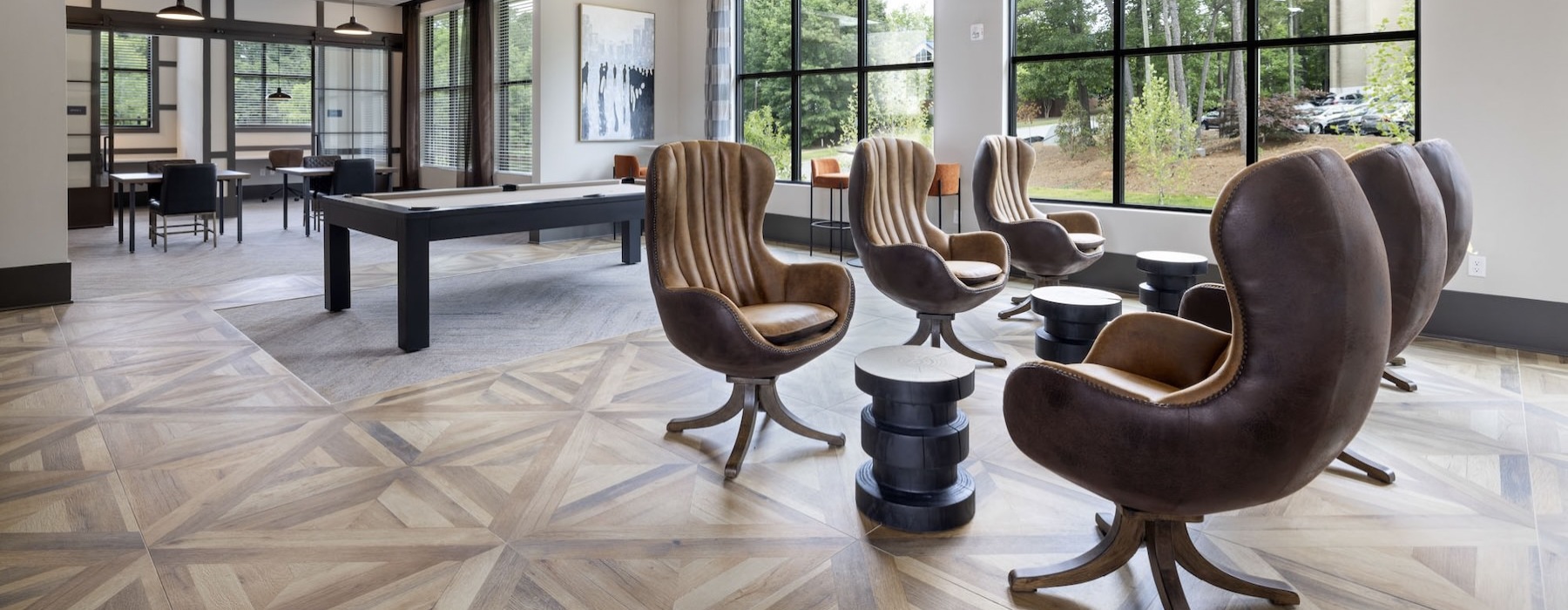 a clubroom with a pool table and chairs