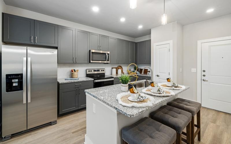 a kitchen with black cabinets